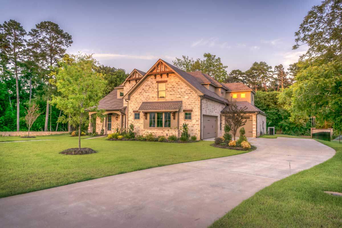 A large, elegant upper-income home representing wealth protection and estate planning for future generations.