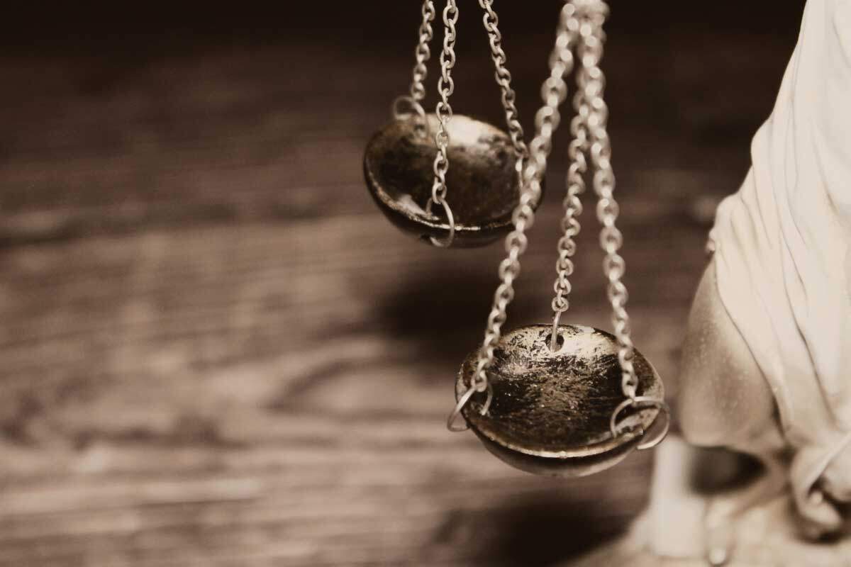 A close-up of the Scales of Justice held by a statue, symbolizing fairness, legal expertise, and professional representation.