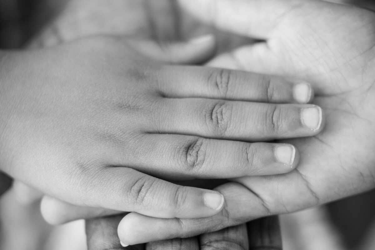 A childs hand being held by an adult